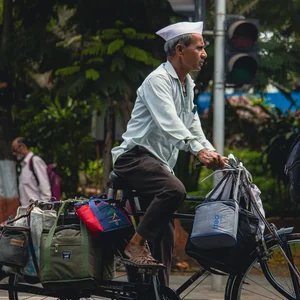 A dabbawala carrying tiffin boxes in Mumbai