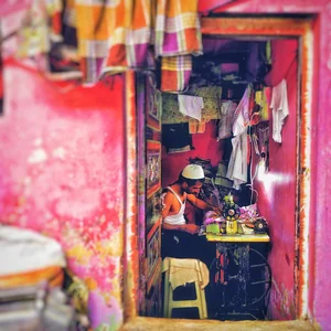 A tailor at work in a Dharavi workshop