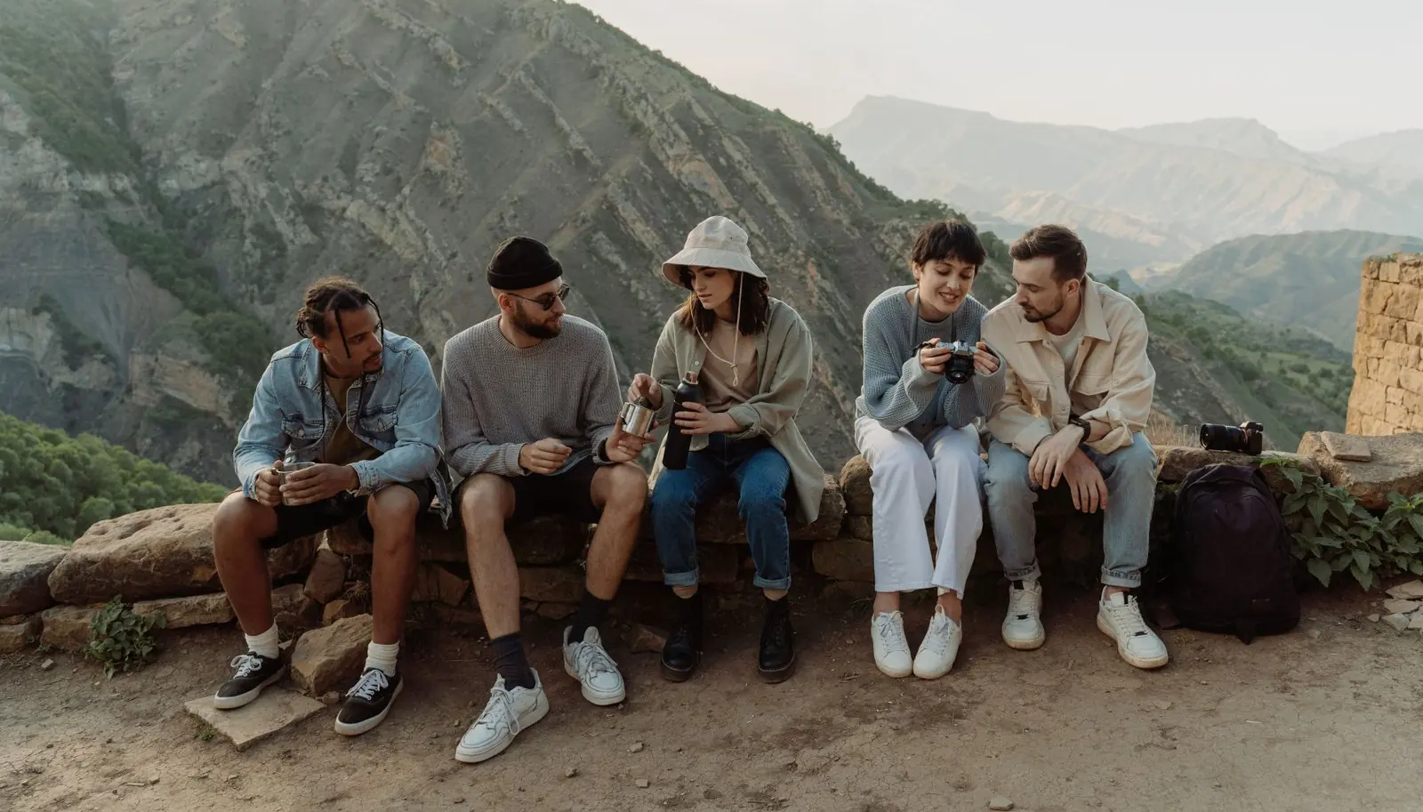 Small group of travellers sitting together in a mountain village